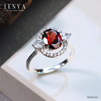 LENYA แหวนโกเมน (Garnet)  สีแดงแก่ก่ำ ช่วยปกป้องคุ้มครอง และช่วยให้สมปรารถนาในเรื่องหน้าที่การงาน การเงินและเรื่องความรัก ล้อมรอบด้วยคิวบิคเซอร์โคเนีย 22 เม็ด บนตัวเรือนเงินแท้ 925 ชุบทองคำขาว