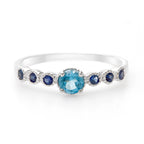 LENYA แหวนเงินแท้ 925 ชุปทองคำขาว ประดับพลอย สีฟ้า บลูโทแพซ (Blue Topaz) ชูเด่นกับดีไซน์เล็กน่ารักๆ  เพิ่มเสน่ห์ดึงดูด กับพลอยสีน้ำเงิน ไพลิน(Blue Sapphire)  ตรงบ่าข้างดูสะดุดตา น่าหลงไหล